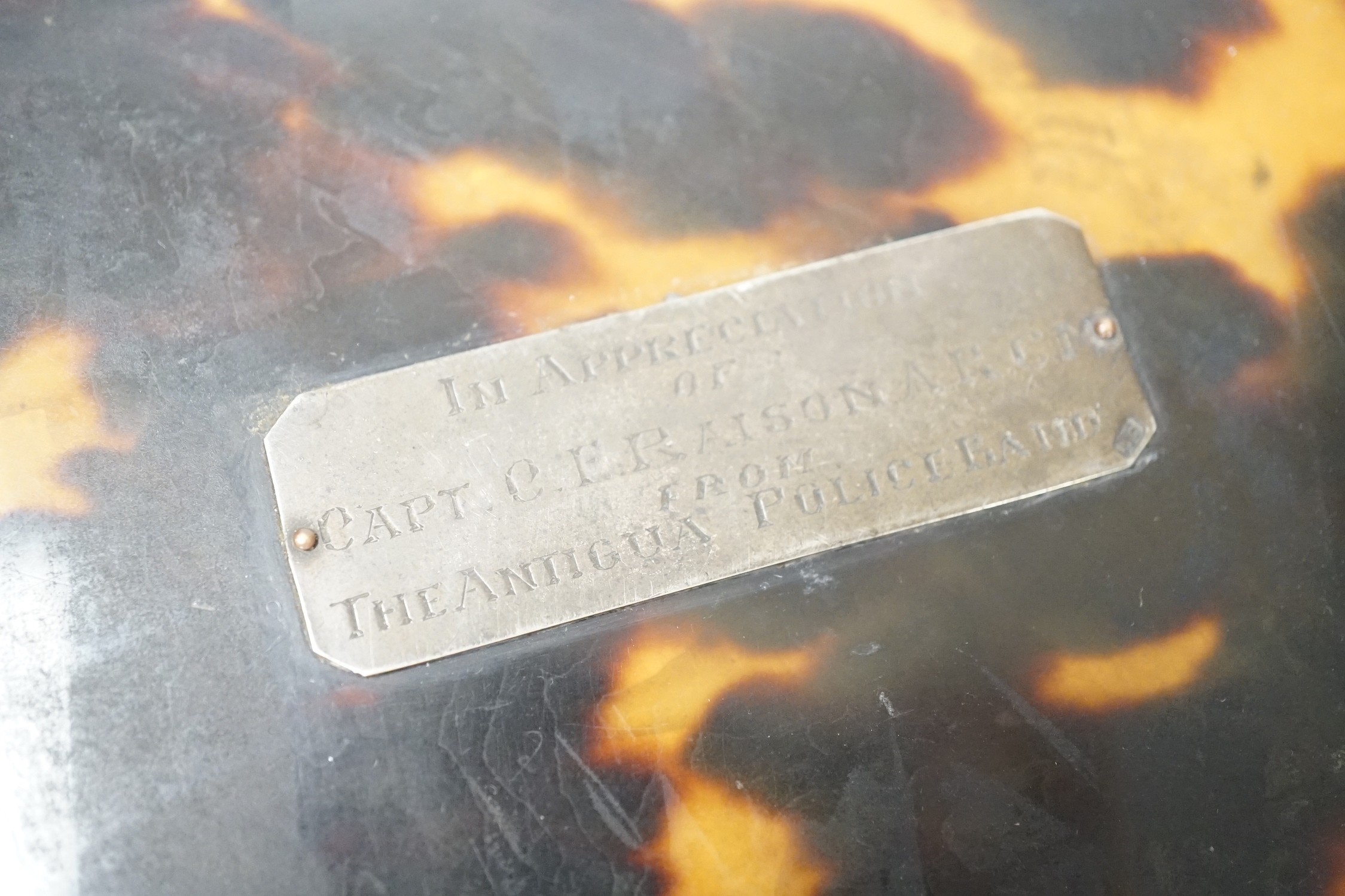 A silver-mounted tortoiseshell box, inscribed ‘In Appreciation of Capt C.E. Raison A.R.C.M. From the Antigua Police Band’. 13cm wide
